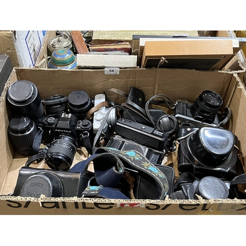 34 - A box of cameras and accessories