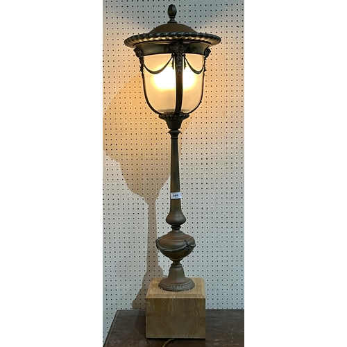 369 - An early 20th Century electroplated newel post lamp with frosted glass shade on wood base. 42