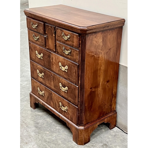 385 - An 18th Century walnut and inlaid Norfolk chest with canted top and fluted corners, the cupboard doo... 