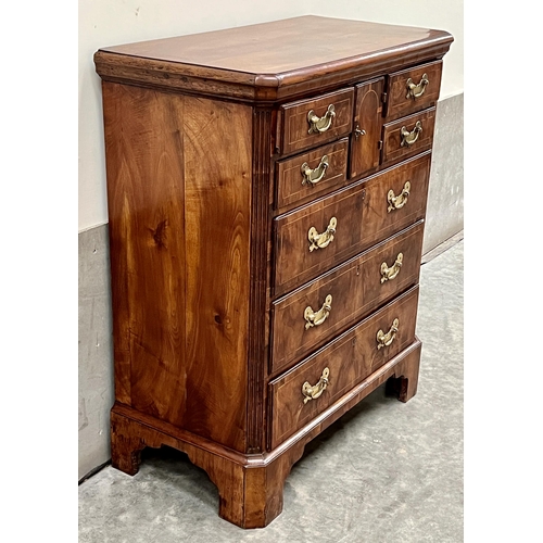 385 - An 18th Century walnut and inlaid Norfolk chest with canted top and fluted corners, the cupboard doo... 