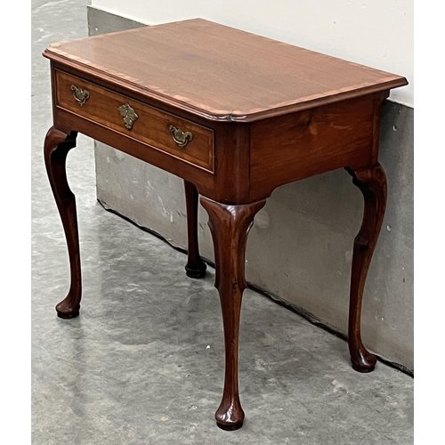 386 - A George II walnut and crossbanded side table, the moulded top with re-entrant corners, over a friez... 