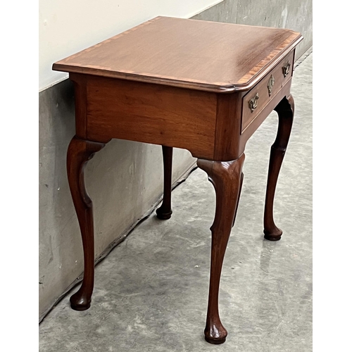 386 - A George II walnut and crossbanded side table, the moulded top with re-entrant corners, over a friez... 