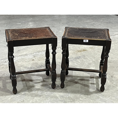 400 - A pair of early 20th century oak stools with leather seats