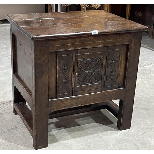 406 - A 17th century style joined chest with hinged lid over a geometrically carved door on square legs. 2... 