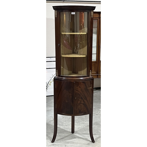 407 - A mahogany bow-fronted corner display cabinet. 67½