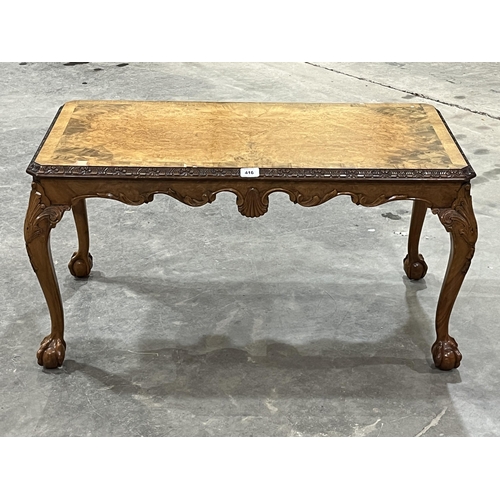 416 - A walnut low table on cabriole ball and claw legs. 37