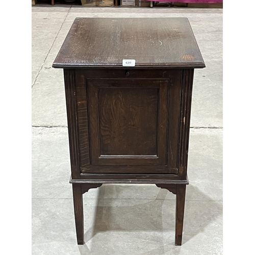 420 - A 1920s oak record cabinet with fall front. 18½