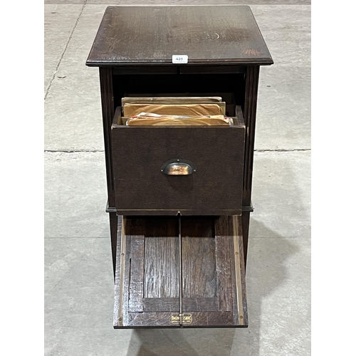 420 - A 1920s oak record cabinet with fall front. 18½