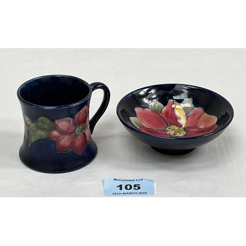 105 - Moorcroft. A tube-lined mug, 2¼' high and a small footed bowl, 3¾