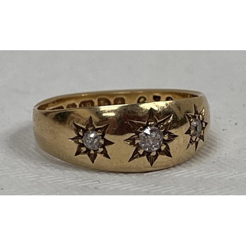 106 - A three stone gypsy set ring. In gold marked 18. 4g gross. Size L