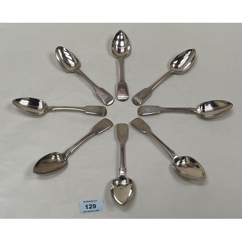 129 - A set of eight William IV silver fiddle pattern dessert spoons. Crested. London 1831. 11ozs 9dwts