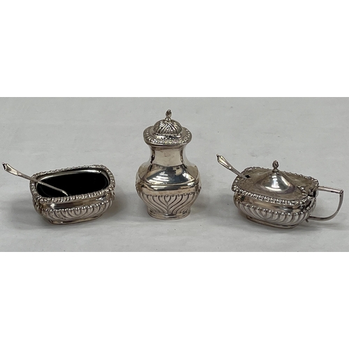 136 - A George V silver half-gadrooned three piece condiment set. Birmingham 1910. 5ozs