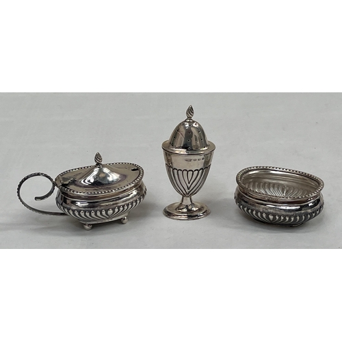 137 - A Victorian silver half-gadrooned three piece condiment set. Birmingham 1896. Liners lacking. 4ozs