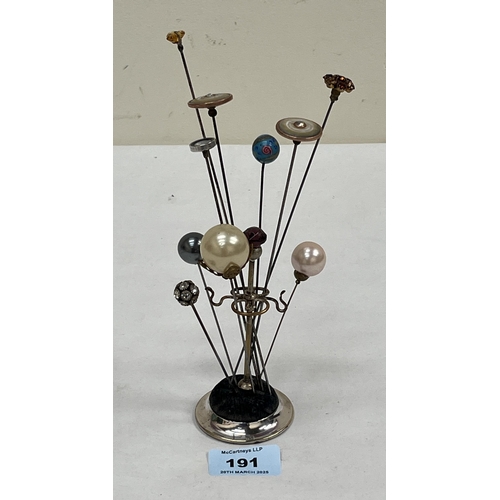 191 - A selection of hatpins on a plated stand