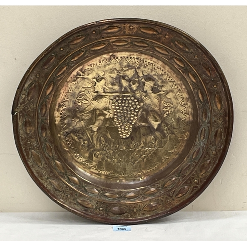 198 - An antique Nuremberg brass alms dish, the centre decorated with the two thieves from the land of Can... 