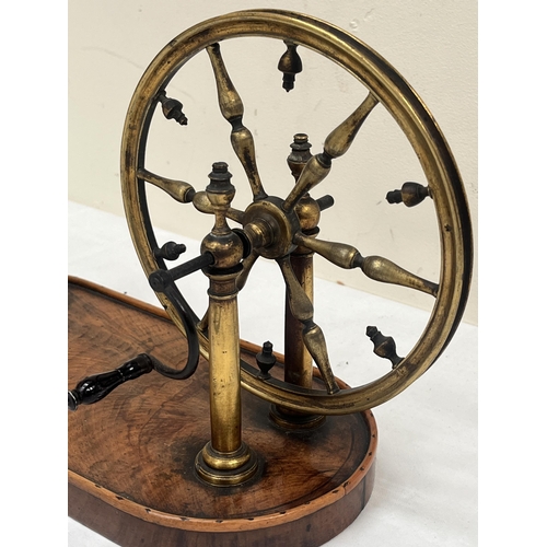 199 - A 19th century French gilt brass rouet or table yarn winder on burr wood plinth base. 12½