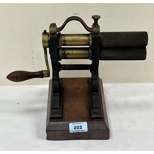 202 - A Victorian brass and cast iron collar or cuff crimping machine on oak base. 9