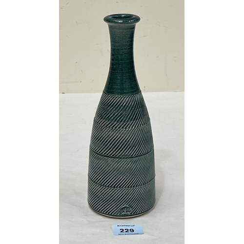 229 - A Poole Pottery bottle vase with wrythen banded incised decoration in green. Impressed marks. 10