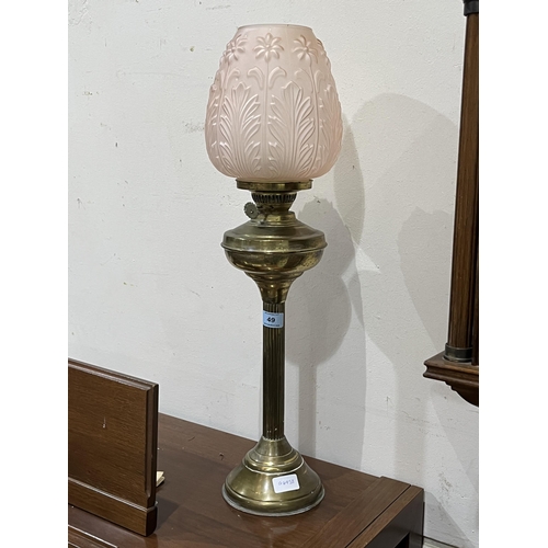 49 - A brass oil lamp with pink frosted shade. 26