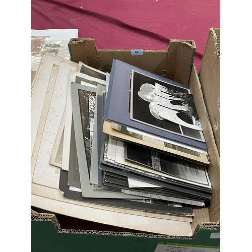 93 - A box of photographs and a collection of unframed pictures