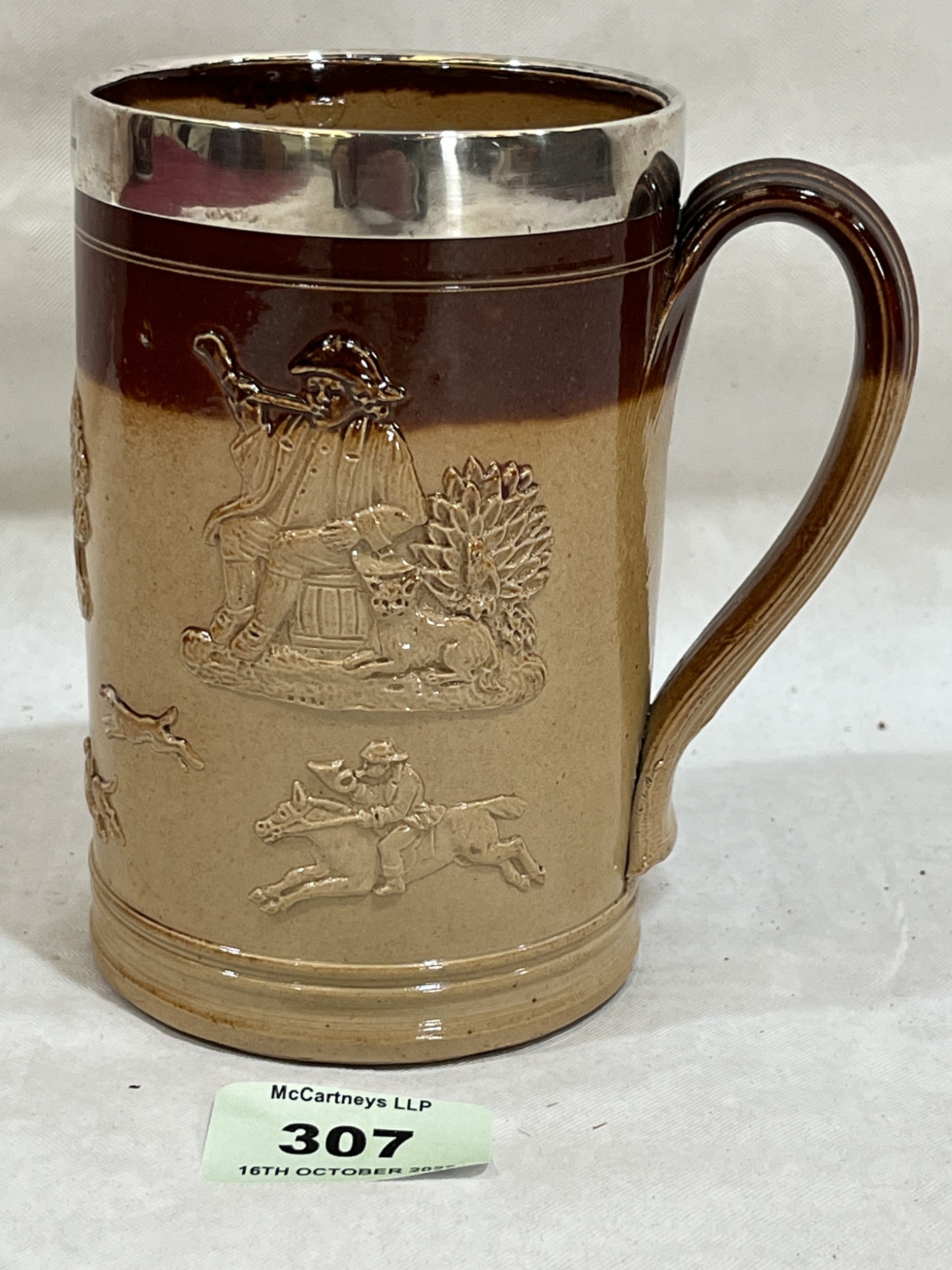 A Victorian sprigged Doulton Lambeth mug with silver rim. London 1895 ...