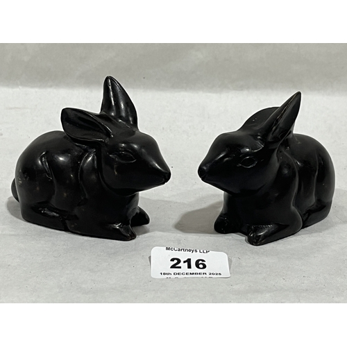 A pair of cast bronze models of rabbits, 4¼' long