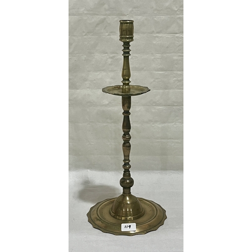119 - An 18th century brass church candlestick. 21in high