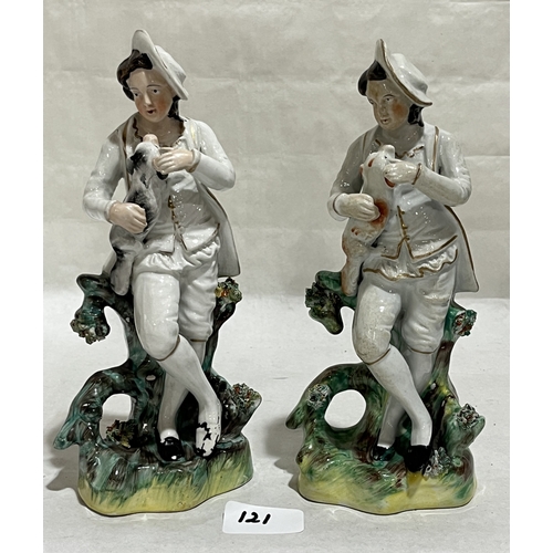 121 - A pair of 19th century Staffordshire porcelaneous figures. 9in high