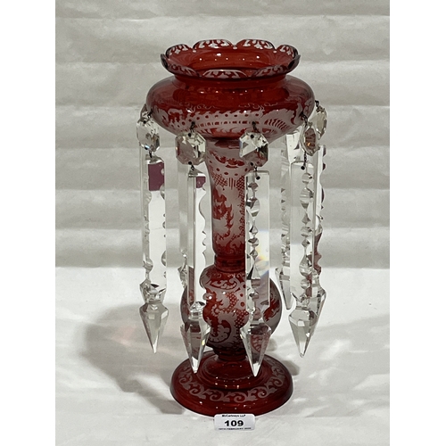 A 19th century etched ruby glass table lustre, hung with prismatic ...