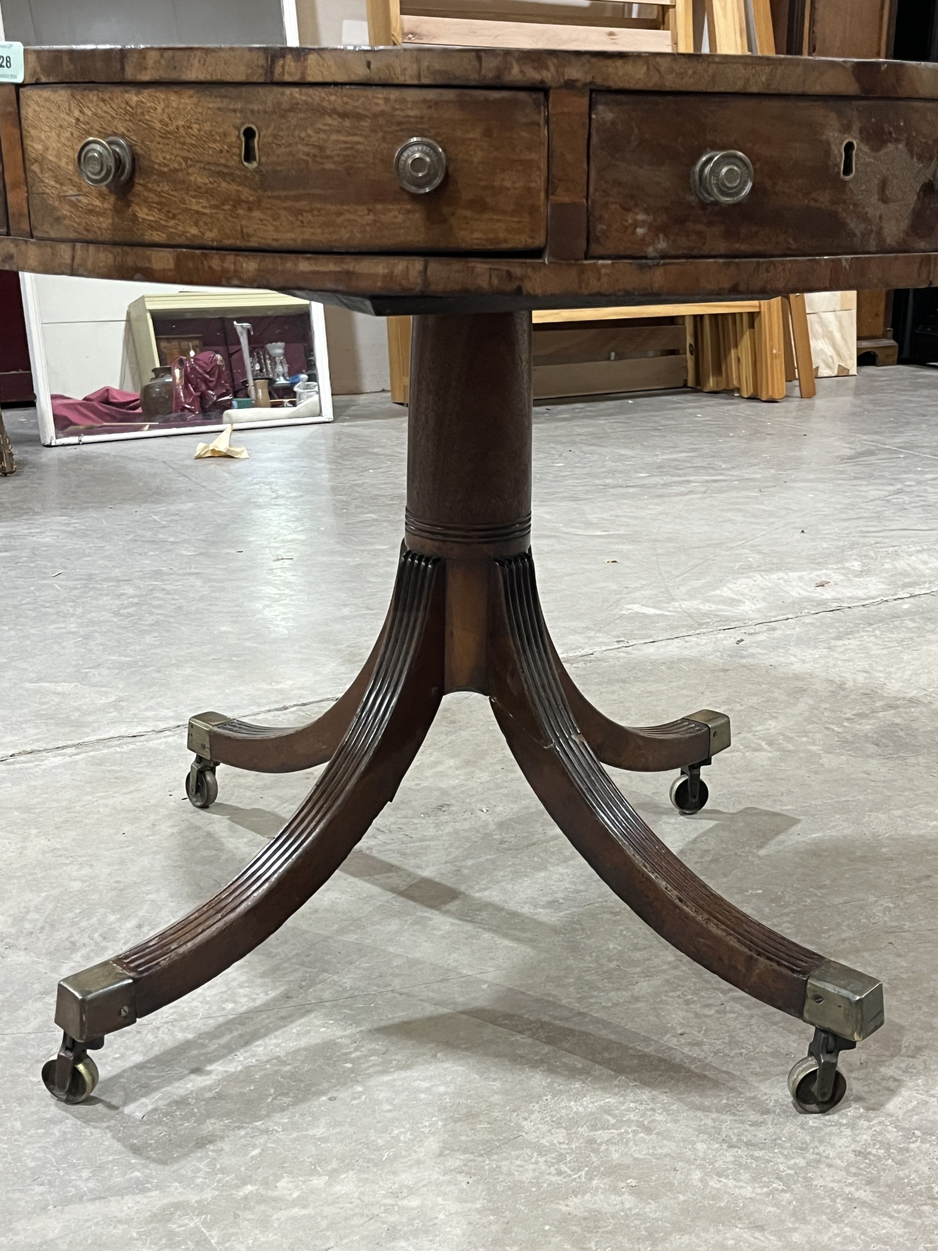 A Regency mahogany drum table, the leather inlet top with eight ...