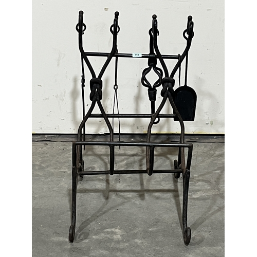 A wrought iron fireside log stand with five tools. 31½in high