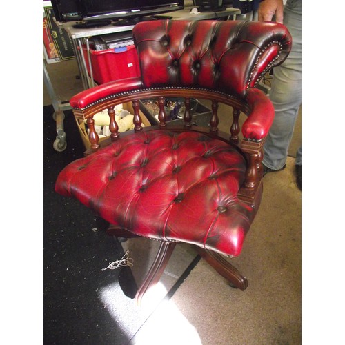 522 - Ox blood red Chesterfield captains swivel chair.