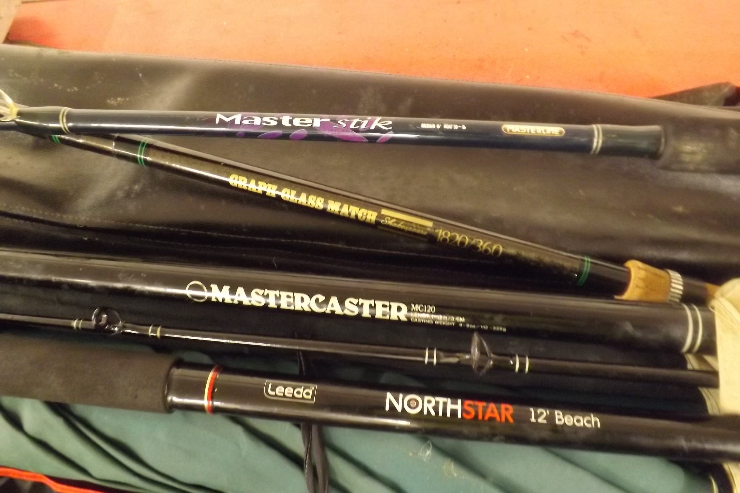 4 good quality hardly used fishing rods names in photo. includes ground parasol, rod tripods, landin