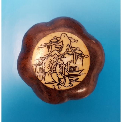 38 - A small foldaway compass in a Chinese Design with carved bone inlay in set in a wooden case.