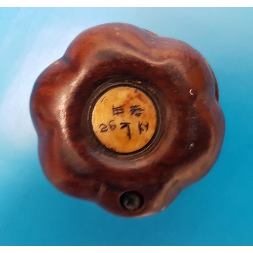 38 - A small foldaway compass in a Chinese Design with carved bone inlay in set in a wooden case.