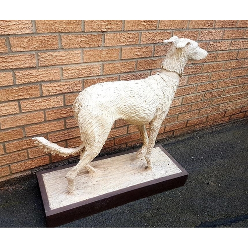 44 - Lifesize realistic Ceramic Sculpture of a Lurcher dog on a wooden plinth, measuring 87cm in height x... 