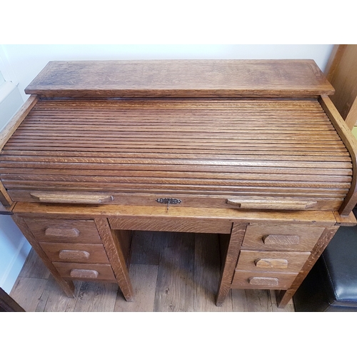 114 - Oak Roll Top Desk, early 20th century.  Tambour roller shutter above central drawer, which is flanke... 