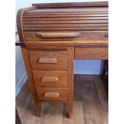 114 - Oak Roll Top Desk, early 20th century.  Tambour roller shutter above central drawer, which is flanke... 