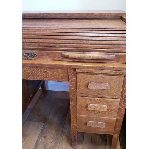 114 - Oak Roll Top Desk, early 20th century.  Tambour roller shutter above central drawer, which is flanke... 