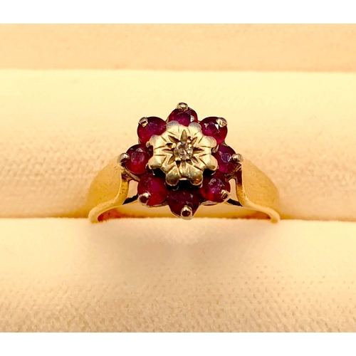 3 - A 9ct Gold, Ruby & Diamond cluster ring, hallmarked MS&S, Size J/K.  Ring set to centre with a round... 