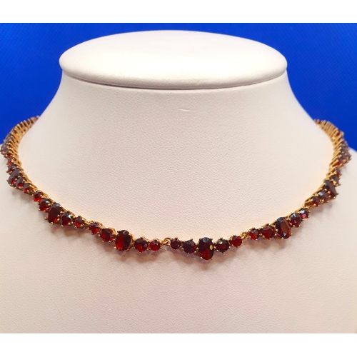 32 - 9ct Gold Garnet Necklace.  Length is 16 inches and weight is 20g