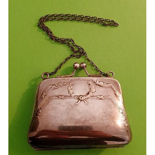 41 - A Decorated EPNS Purse on white metal chain