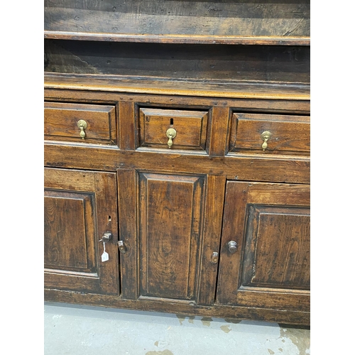 125 - 18th cent. Welsh oak dresser with ornate fruit wood frieze to shelves. Base with two long drawers an... 