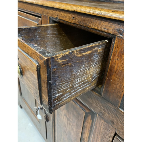 125 - 18th cent. Welsh oak dresser with ornate fruit wood frieze to shelves. Base with two long drawers an... 