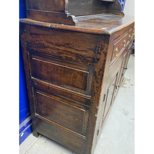 125 - 18th cent. Welsh oak dresser with ornate fruit wood frieze to shelves. Base with two long drawers an... 