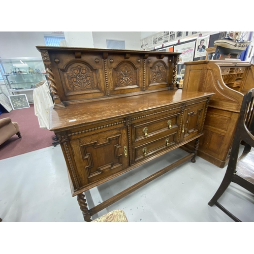 73 - 20th cent. Oak buffet with stylised rose decoration to backboard. 60ins. x 53ins. x 22ins.