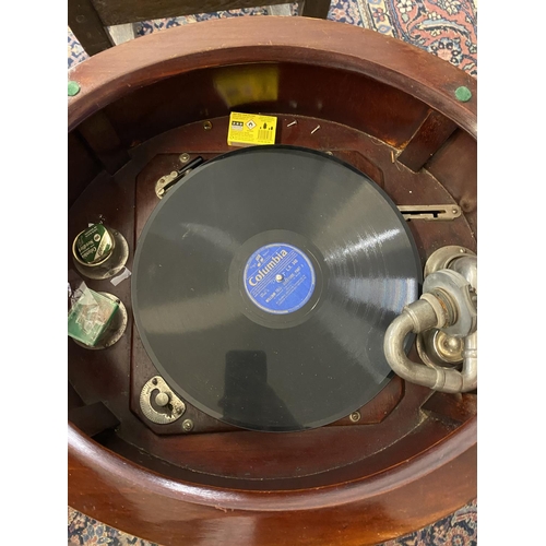 90 - Ear;y 20th cent. 'Tyrela' mahogany oval wind up gramophone on four supports, double doors to front a... 