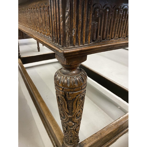 99 - 18th cent. Oak refectory table with heavily carved tapering supports and inlaid footrest/stretchers.... 