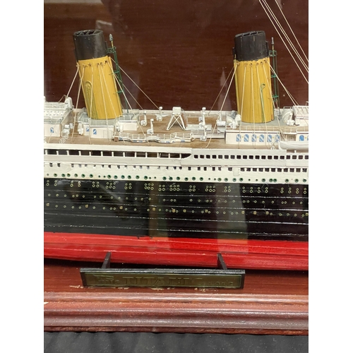 56 - R.M.S. TITANIC: Modern model of the Titanic in display case. 48ins. Plus three folders of Build The ... 