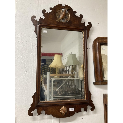 35 - Early 19th cent. Mahogany mirror, shaped top with carved gilded ha ha bird and shaped bottom with gi... 